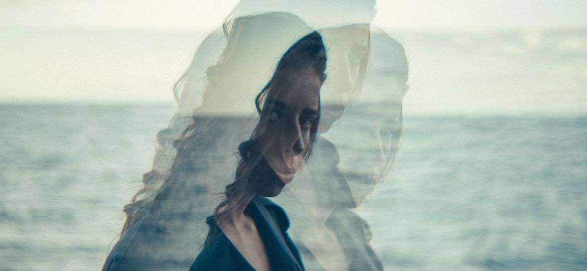 woman standing near body of water